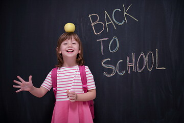 Image showing child holding apple on head