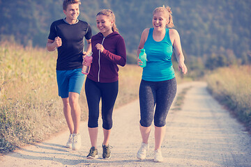 Image showing young people jogging on country road