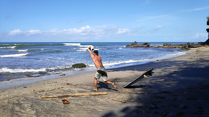 Image showing Surfer man stands on sandy beach