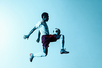 Image showing Male soccer player kicking ball in jump isolated on gradient background