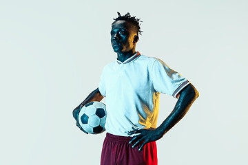 Image showing Male soccer player standing with the ball isolated on white background