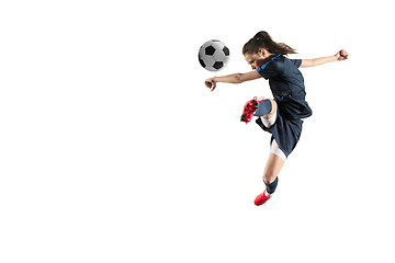 Image showing Female soccer player kicking ball isolated over white background