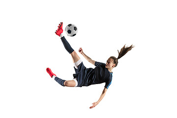 Image showing Female soccer player kicking ball isolated over white background