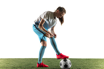 Image showing Female soccer player preparing for the game isolated over white background