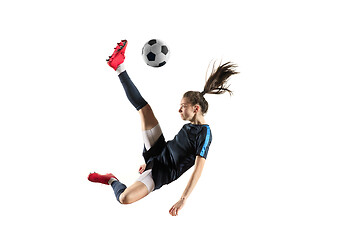 Image showing Female soccer player kicking ball isolated over white background