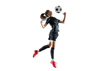 Image showing Female soccer player kicking ball isolated over white background