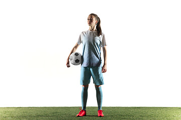 Image showing Female soccer player standing with the ball isolated over white background