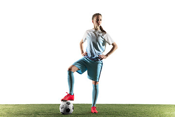 Image showing Female soccer player standing with the ball isolated over white background