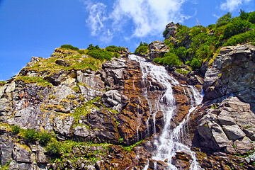 Image showing Rocky waterfall in summer mountain