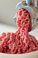 Image showing mince the meat with an electric meat mincer