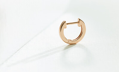 Image showing gold earring on a white background 