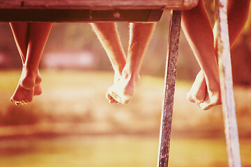 Image showing people sitting at wooden bridge