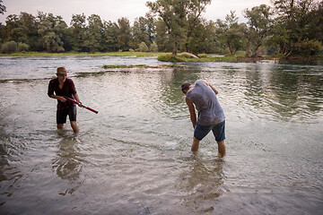 Image showing young men having fun with water guns