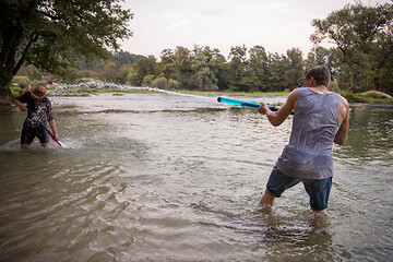 Image showing young men having fun with water guns