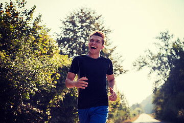 Image showing man jogging along a country road