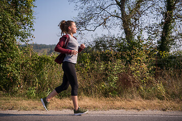 Image showing woman jogging along a country road