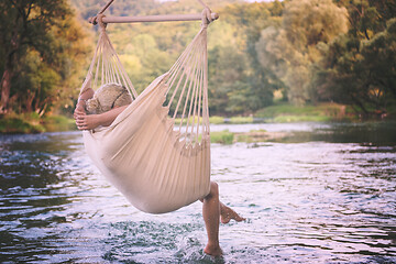 Image showing blonde woman resting on hammock