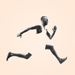 Image showing Young caucasian man running or jogging isolated on studio background.