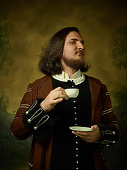 Image showing Young man as a medieval knight on dark background