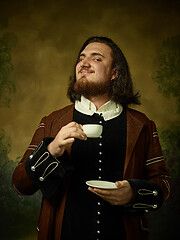 Image showing Young man as a medieval knight on dark background