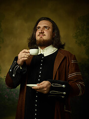 Image showing Young man as a medieval knight on dark background