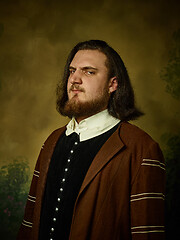 Image showing Young man as a medieval knight on dark background