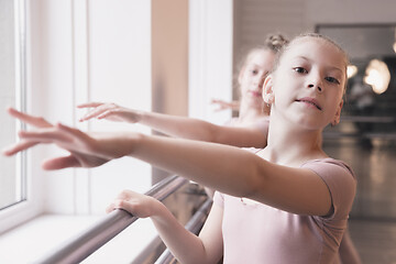 Image showing Young graceful female ballet dancers dancing at training studio