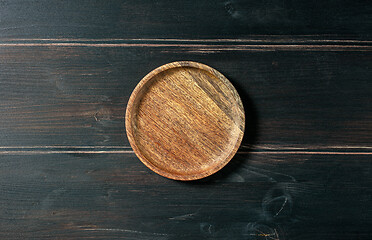 Image showing empty wooden plate on kitchen table
