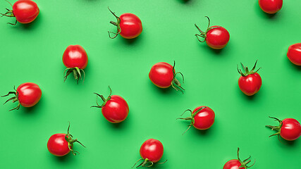 Image showing red cherry tomatoes on green background