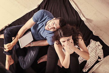 Image showing top view of couple checking a list of things for their unborn ba