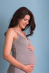 Image showing Portrait of pregnant woman over blue background