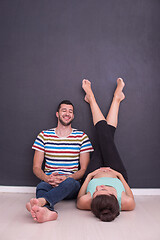 Image showing pregnant couple relaxing on the floor