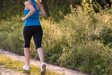 Image showing woman jogging along a country road
