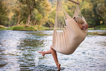 Image showing blonde woman resting on hammock