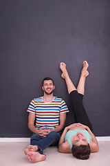 Image showing pregnant couple relaxing on the floor