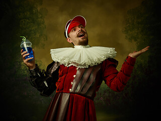 Image showing Young man as a medieval knight on dark background