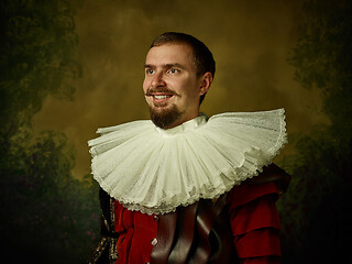 Image showing Young man as a medieval knight on dark background