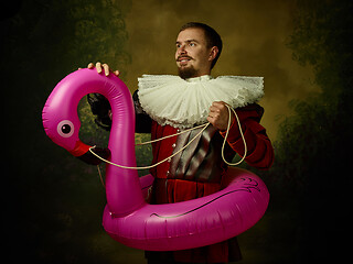 Image showing Young man as a medieval knight on dark background