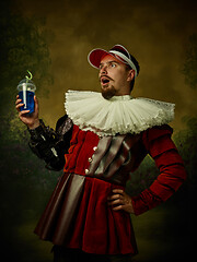 Image showing Young man as a medieval knight on dark background