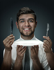 Image showing A young man surrounded by hands like his own thoughts