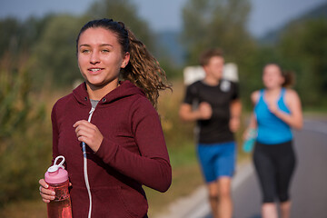 Image showing young people jogging on country road