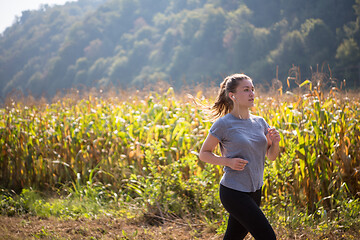 Image showing woman jogging along a country road