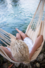 Image showing blonde woman resting on hammock