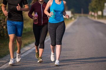 Image showing young people jogging on country road