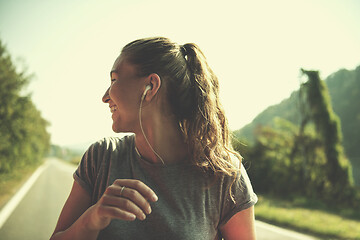 Image showing woman jogging along a country road