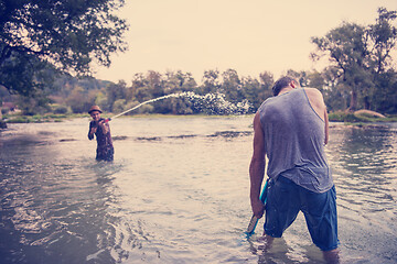 Image showing young men having fun with water guns