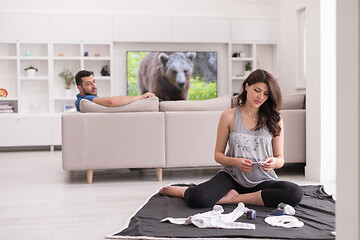 Image showing pregnant couple checking a list of things for their unborn baby