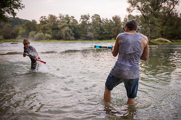 Image showing young men having fun with water guns