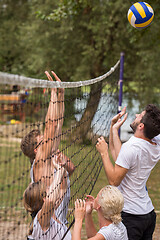 Image showing group of young friends playing Beach volleyball