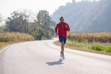 Image showing man jogging along a country road